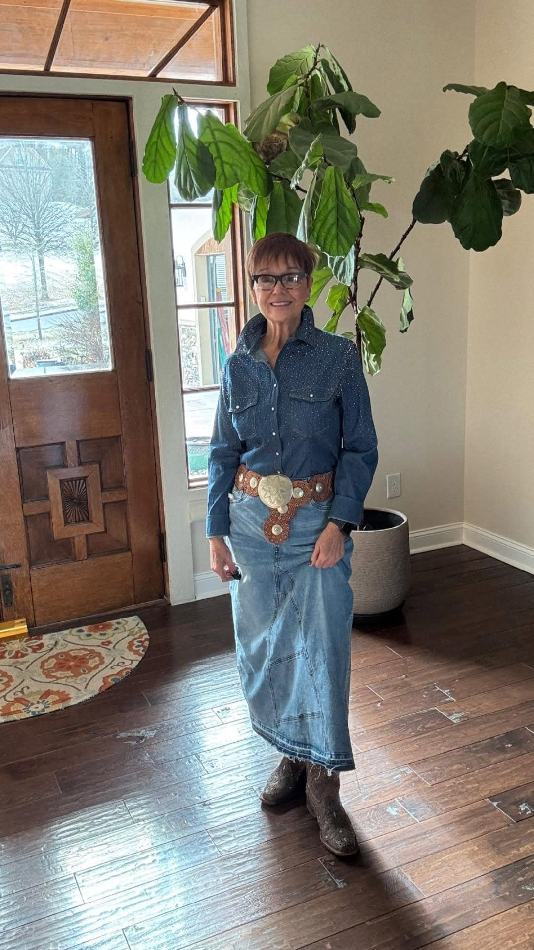 Mindy in a denim-on-denim look with a rhinestone shirt, maxi skirt and western belt